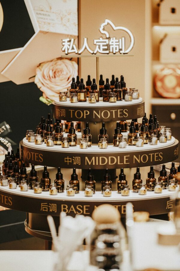 Luxurious perfume display with top, middle, and base notes bottles indoors.